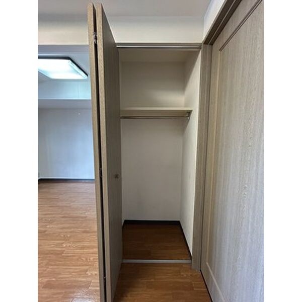 ハンガーパイプと棚のある収納。衣類を整理できます。
