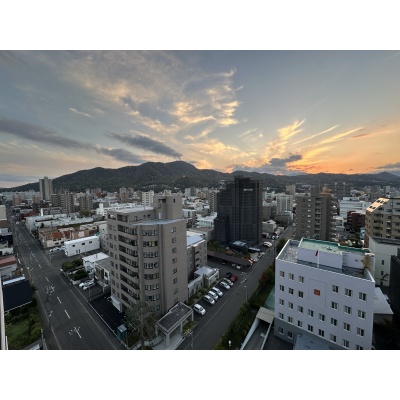 夕暮れ時の街並みを望む眺望。周辺には建物が建ち並びます